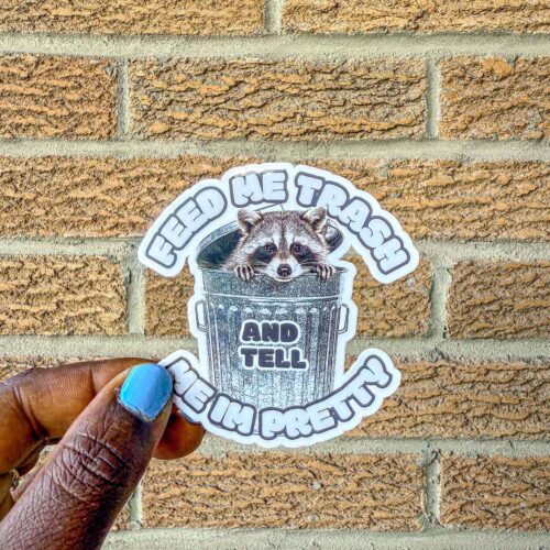 Trash panda sticker that reads "Feed me trash and tell me I'm pretty"