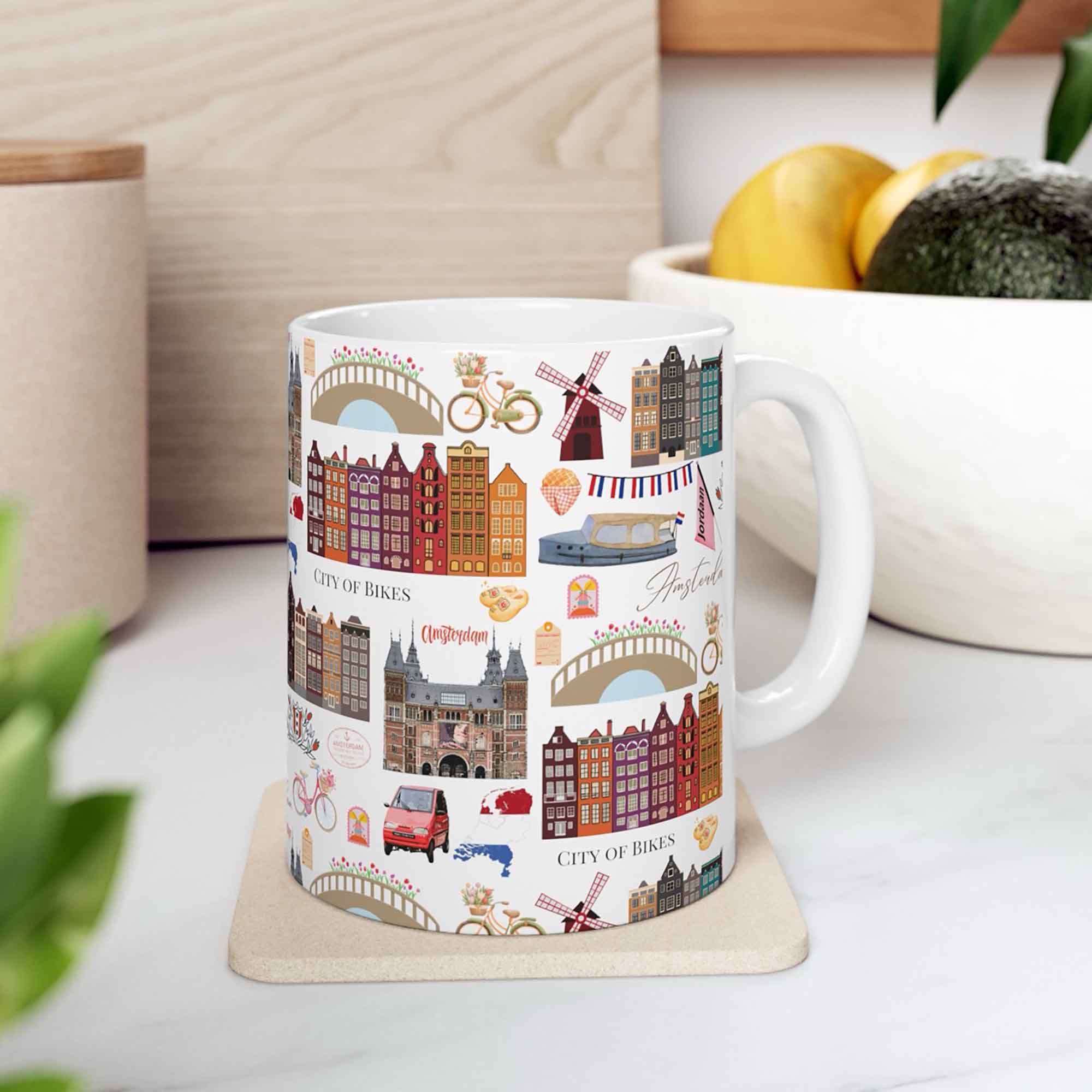 A lifestyle mockup of an Amsterdam themed icon mug with Dutch architecture illustration